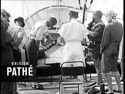 Prince Philip carried ashore at Gizo by war canoe, 1959
