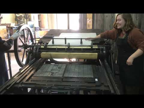 An 1880s newspaper flatbed press in action