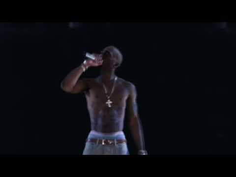 Snoop Dogg performs beside a projection of him at Coachella