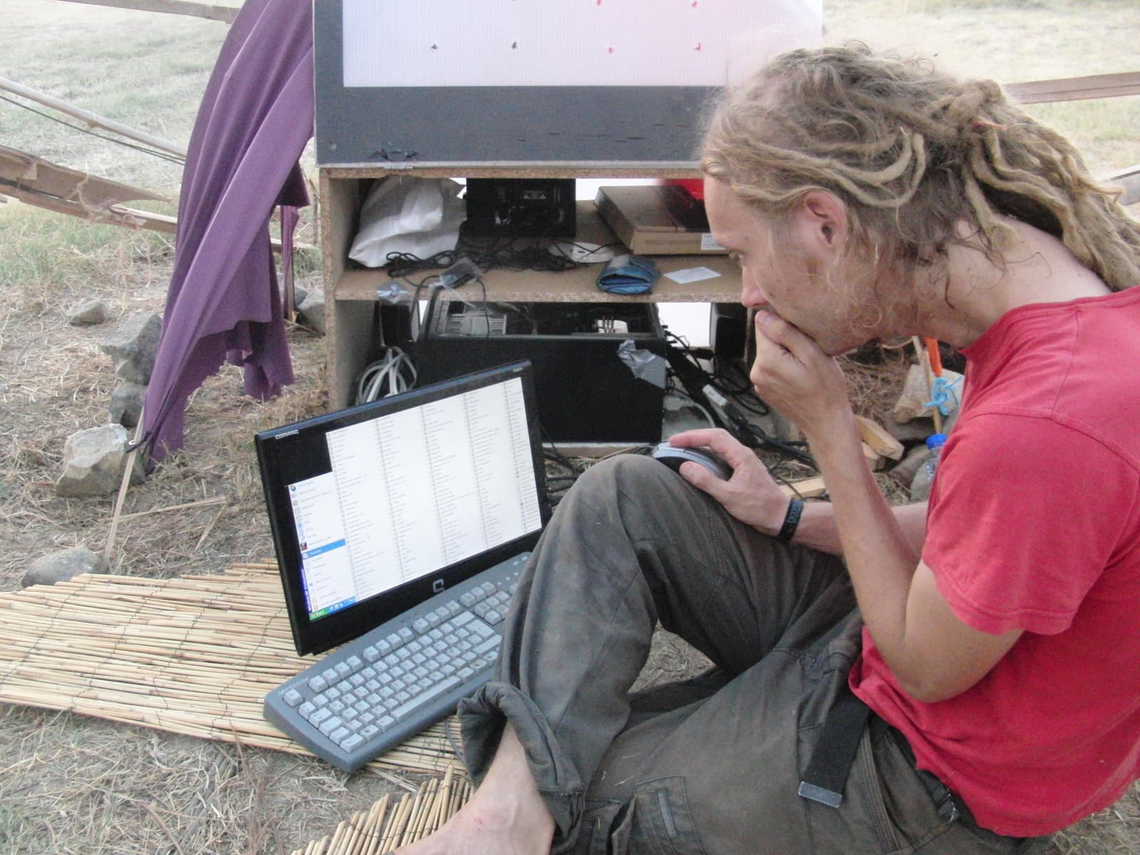 Artist cueing visuals from a laptop on site, Boom 2010