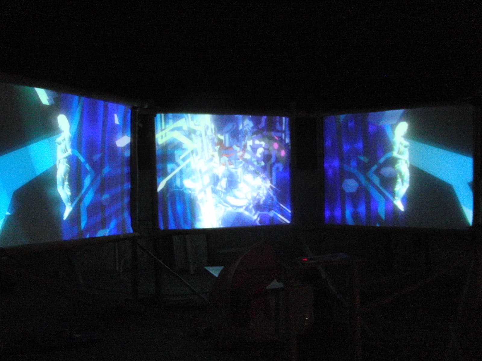 Three screen projection piece lit blue, Boom 2010