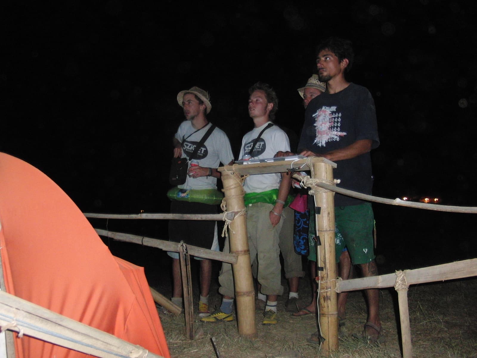 Standing by the bamboo rail at the installation, Boom 2010