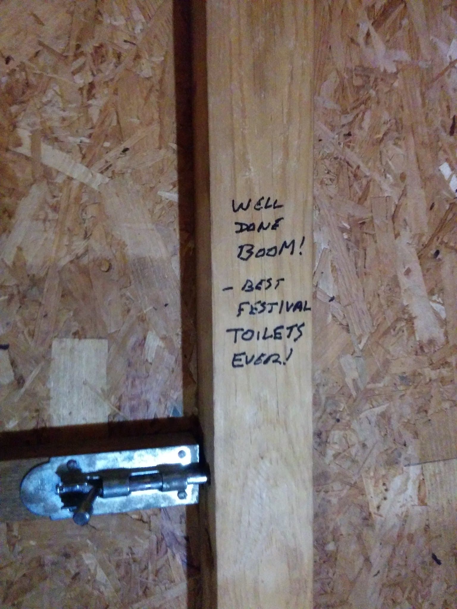 Praise for the compost toilets written on a cubicle wall, Boom 2014