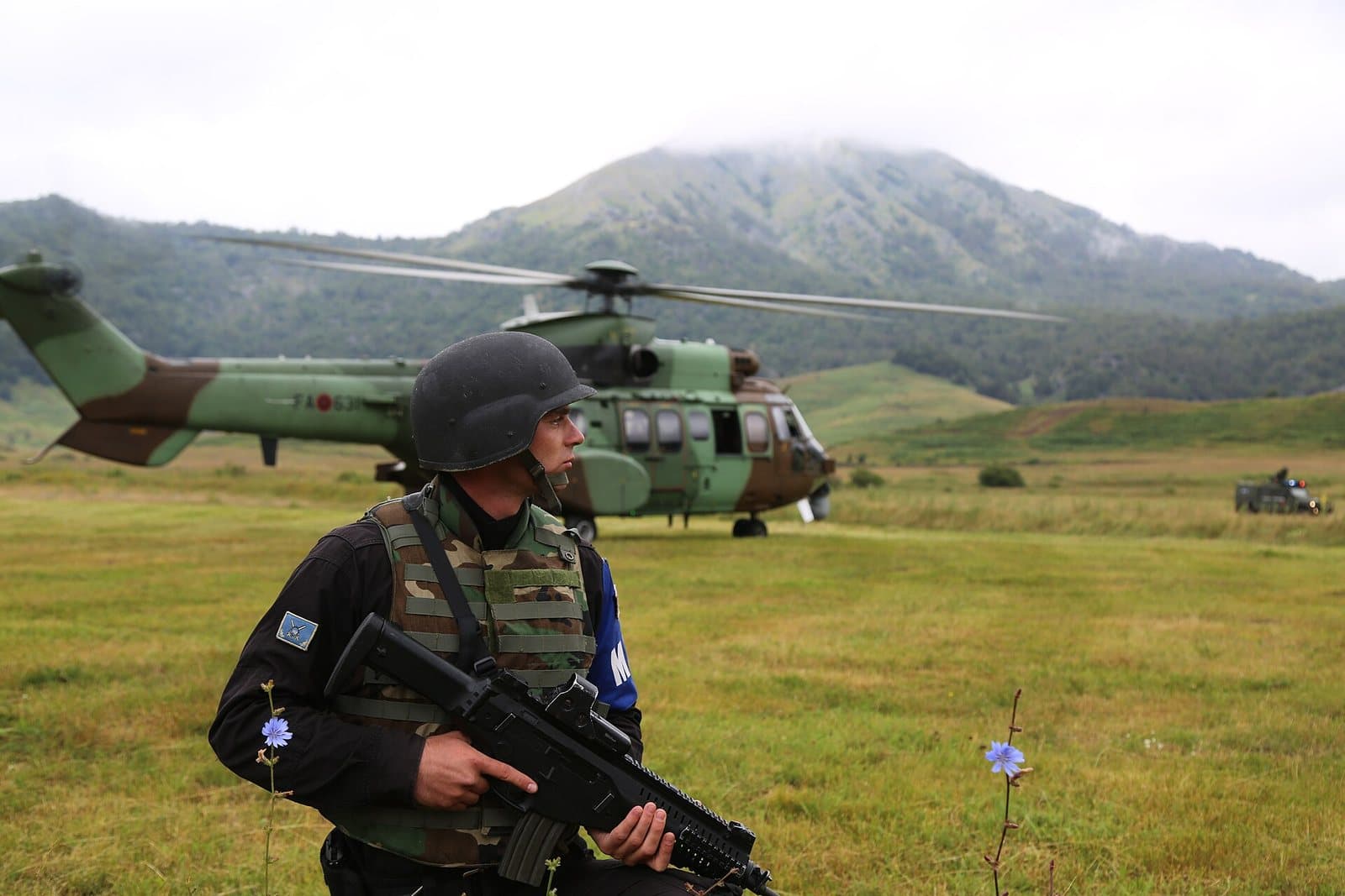 Albanian military police and an army helicopter