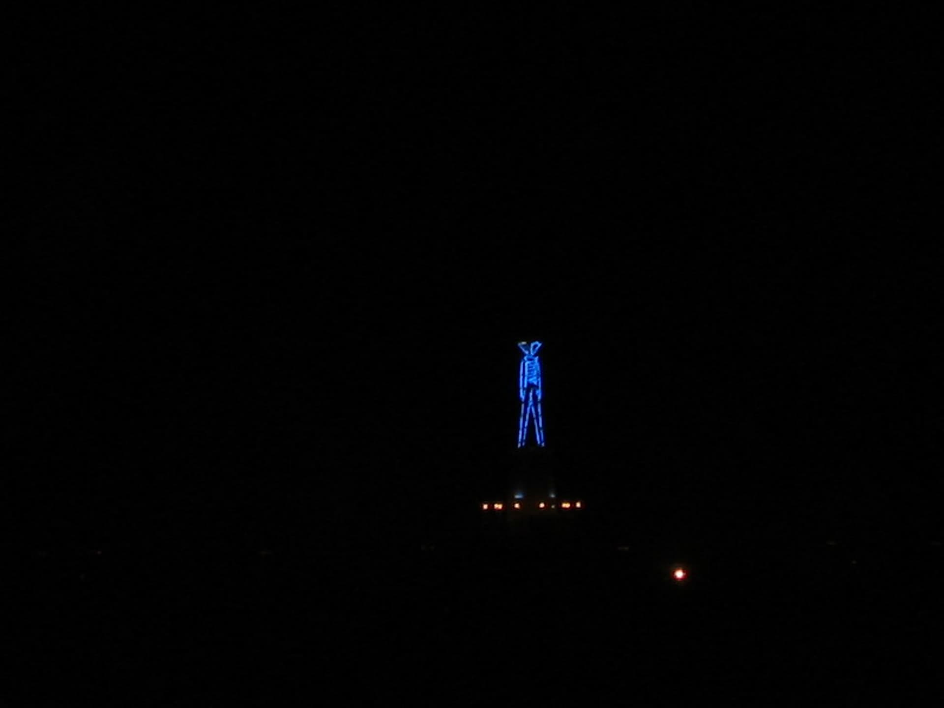 The blue-neon Man on the lighthouse · 1/5