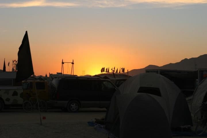 Sunset over the tent city · 3/9