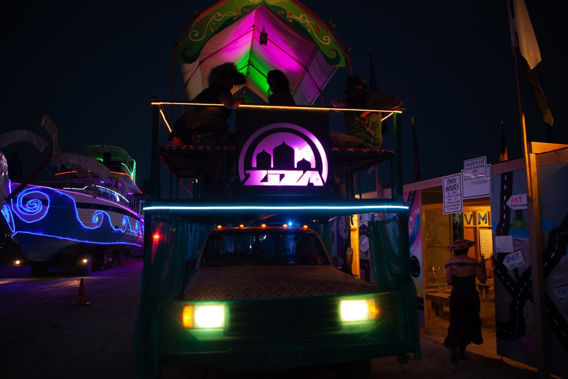 The neon art cars at night · 1/15