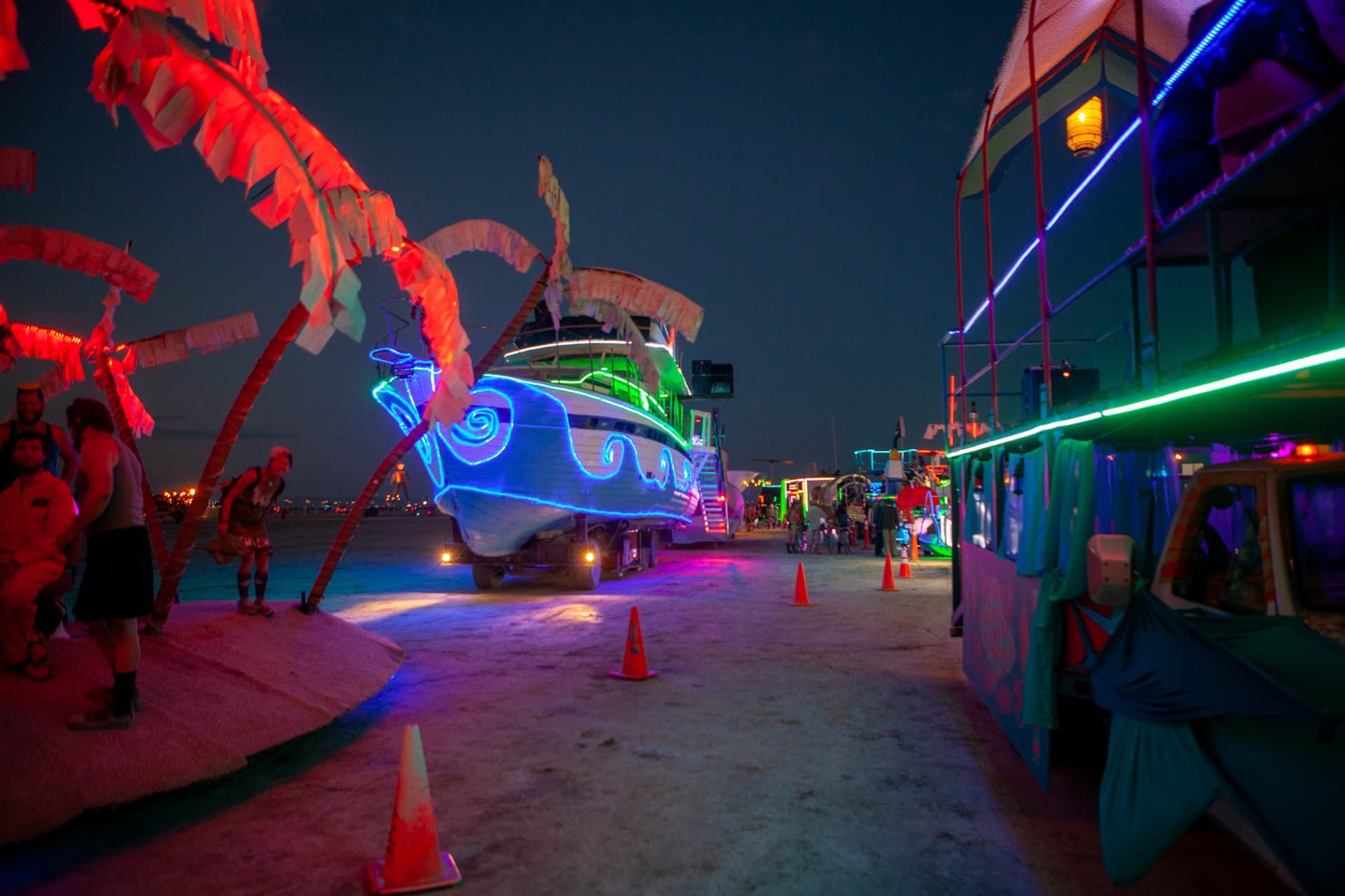 The neon art cars at night · 2/15