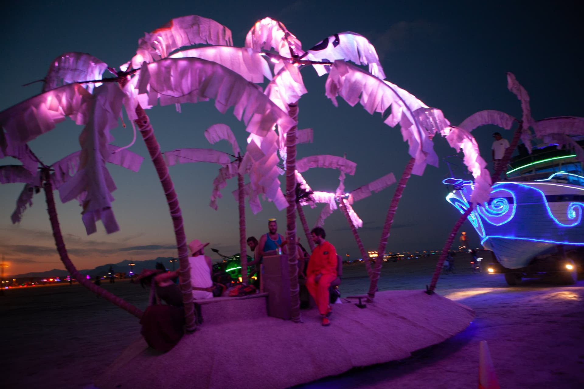 The neon art cars at night · 3/15