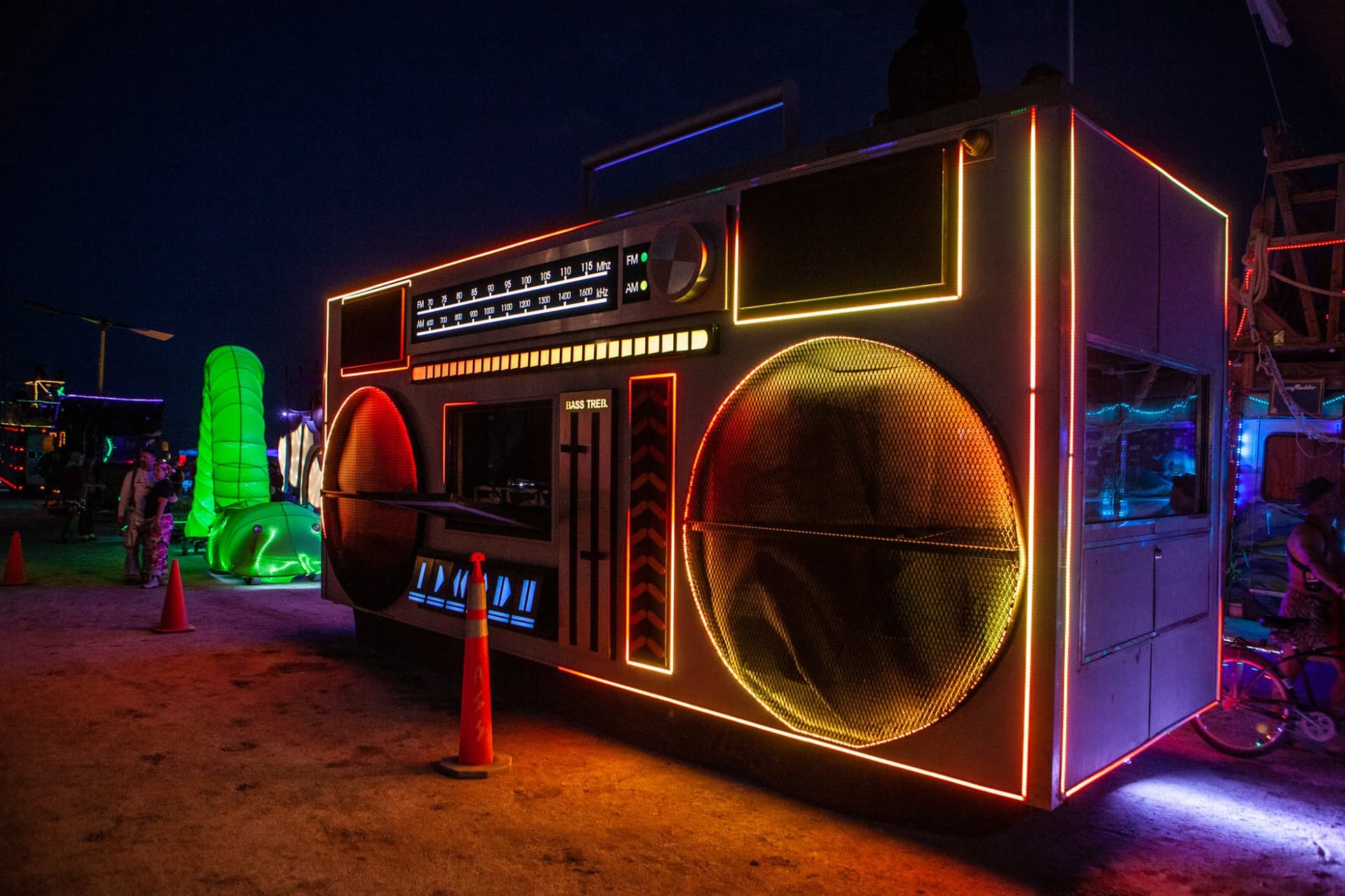 The neon art cars at night · 8/15