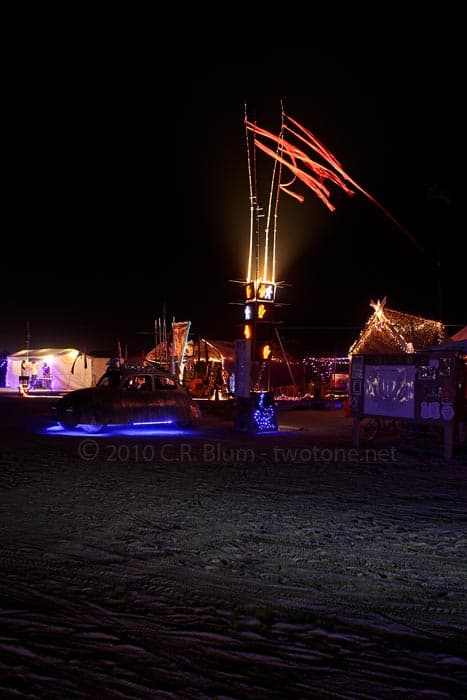 Flags and Lit Camp at Night