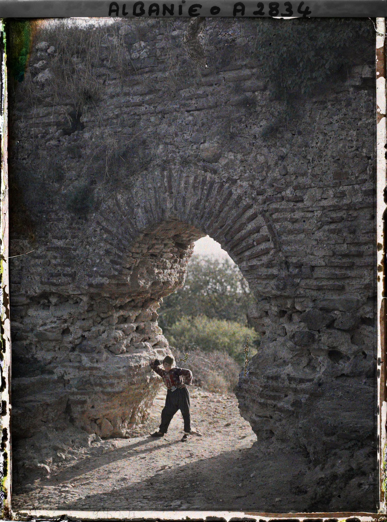 Old brick gate in the Venetian wall, with a young local resident, 1913