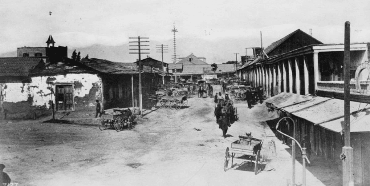 view north from Broad Place up Calle de los Negros towards Del Valle adobe on Plaza. Cor…