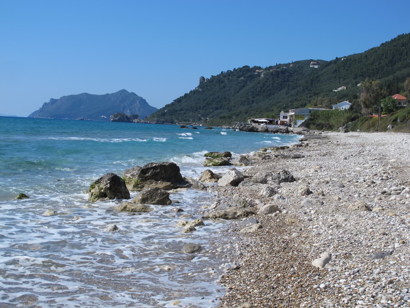The sand and shallow water of Agios Gordios beach (4 of 6)