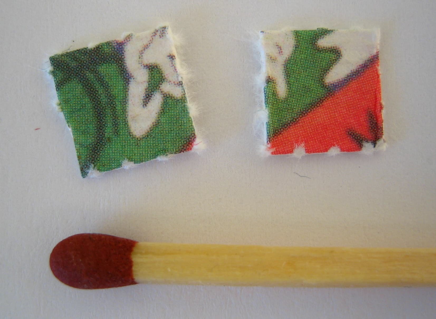 LSD blotter tab beside a match for scale