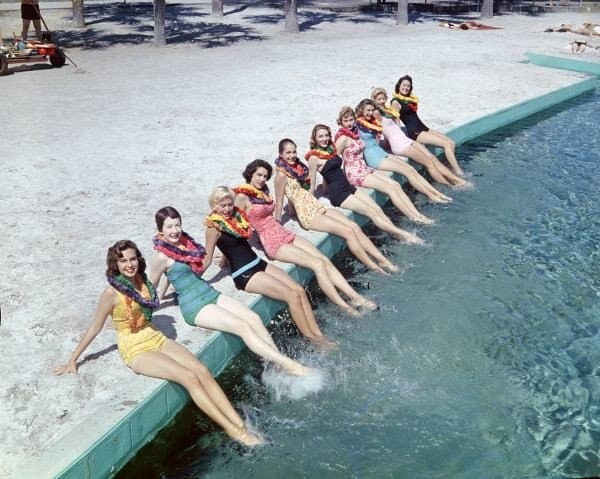 Women in leis and bathing suits at the beach