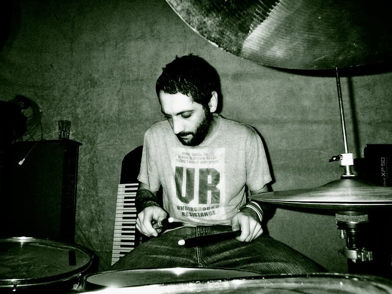 Julio with Underground Resistance T-shirt and playing Back Beat Drums