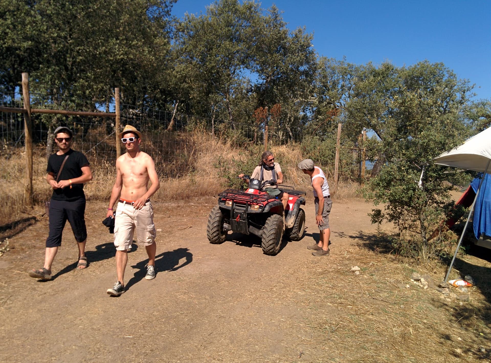 Standing by a quad bike at the camp edge, Boom 2014
