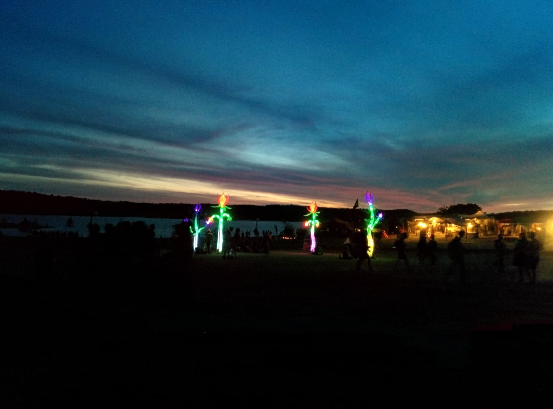 Lit figures along the shore after dark, Boom 2014