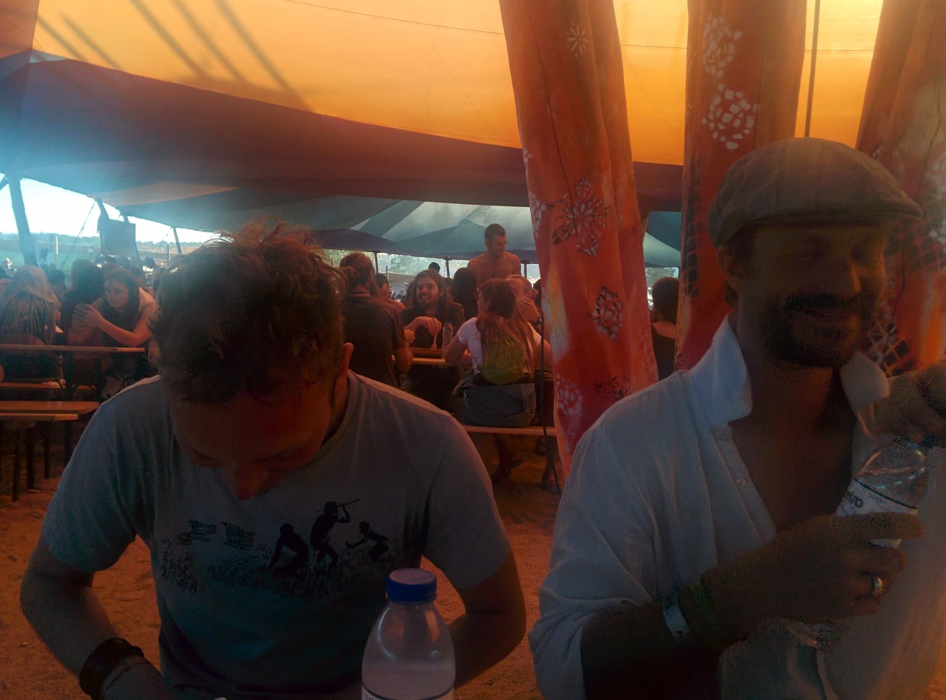 Eating together beneath orange sails, Boom 2014
