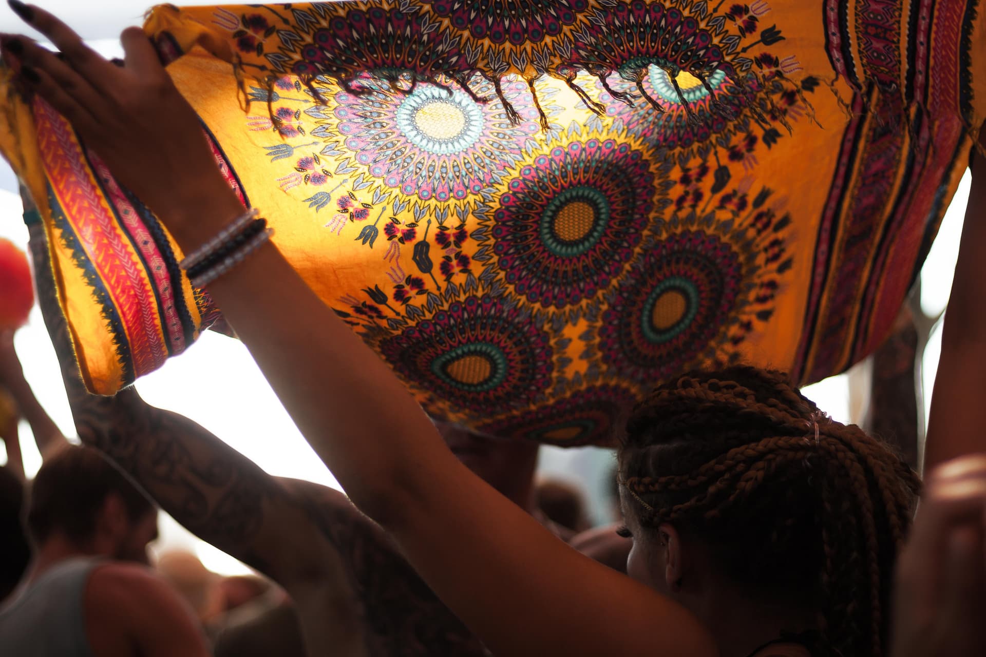 Patterned textile raised against the sun