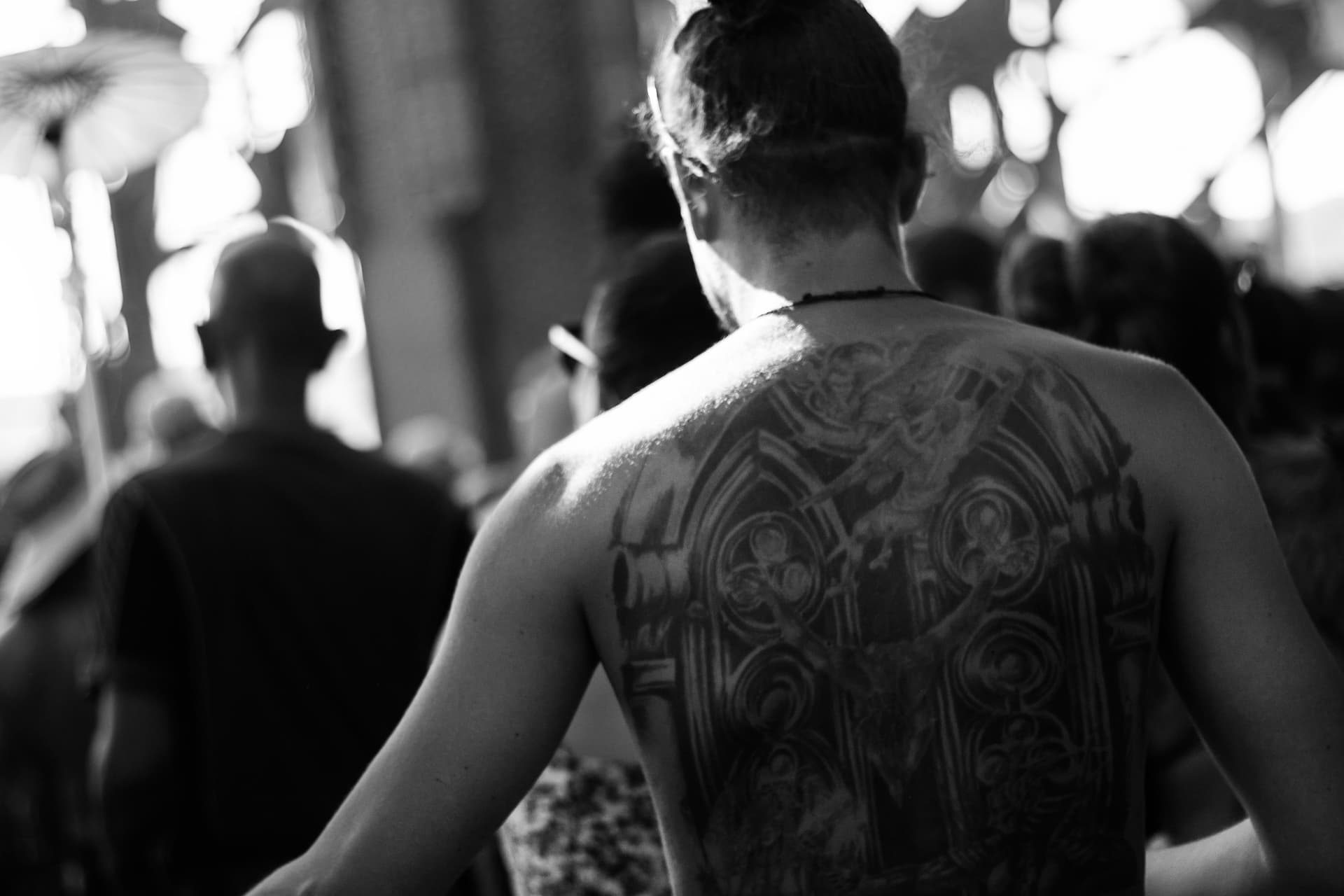 Large back tattoo in the crowd