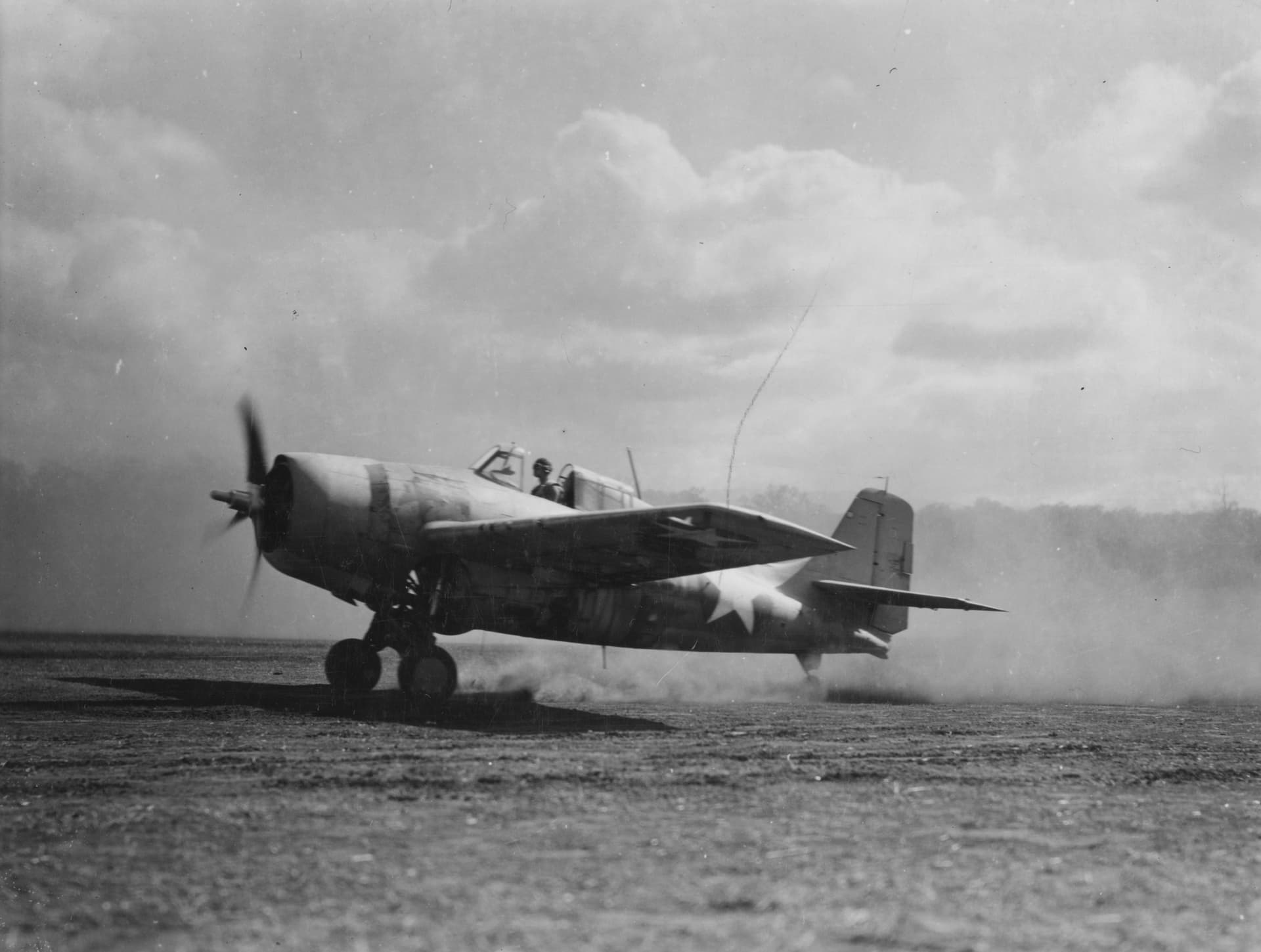 CLOSEUP OF WILDCAT Photographer L.M. Ashman, USMC, Baltimore, Md., was bowled over by the rush of wind from this Grumman Wildcat as it took off from Henderson Field to repulse a Jap aerial bombardment