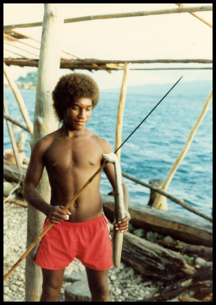 Young man with a sea snake taken by harpoon