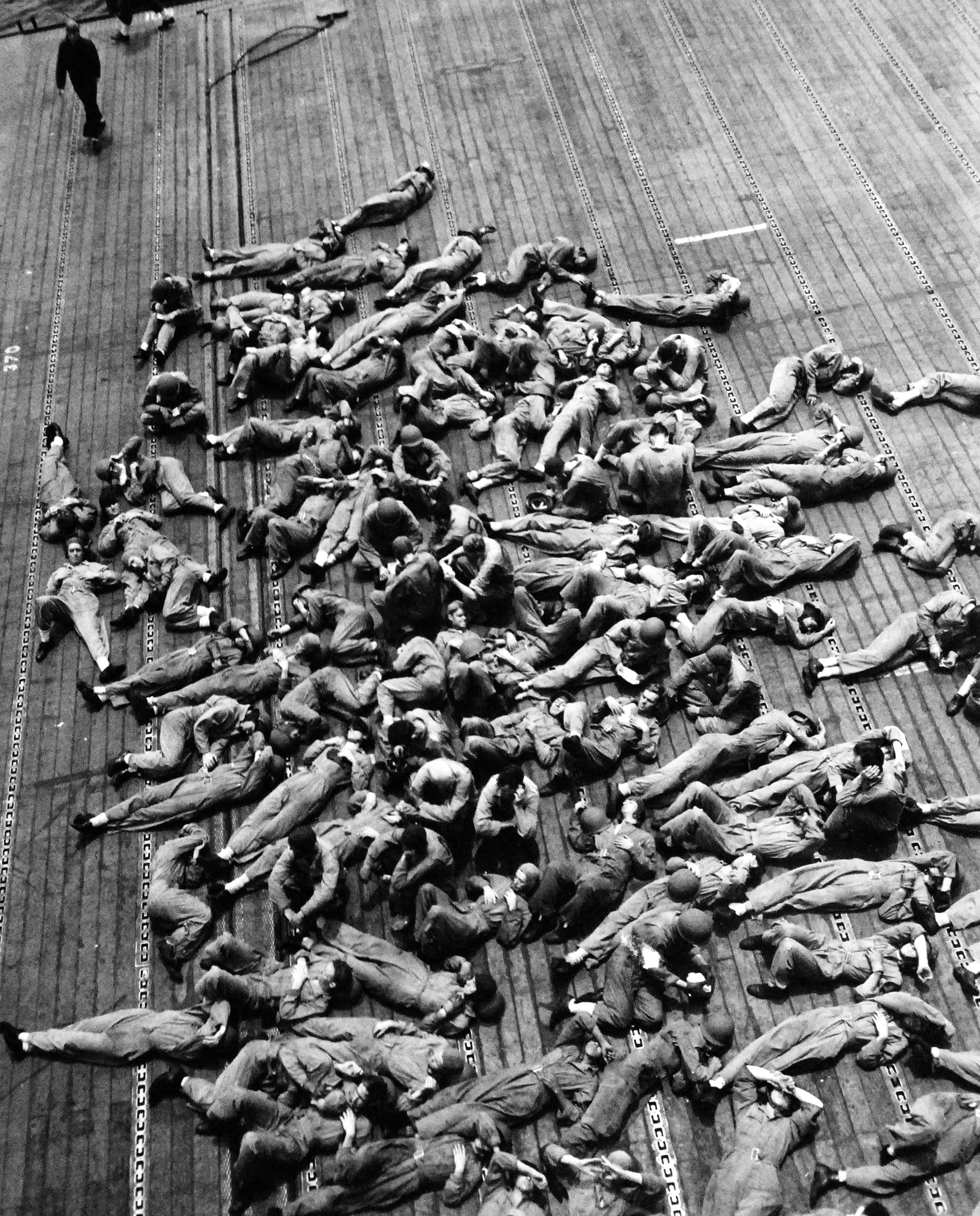 Flight deck crews resting aboard USS Enterprise (CV-6), in November 1942 ( )