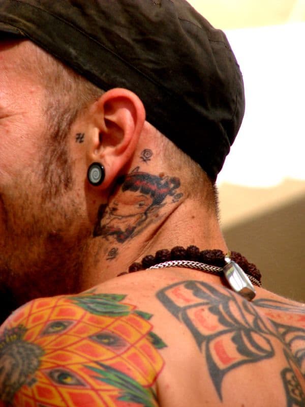 Tattooed shoulders and neck of a visitor