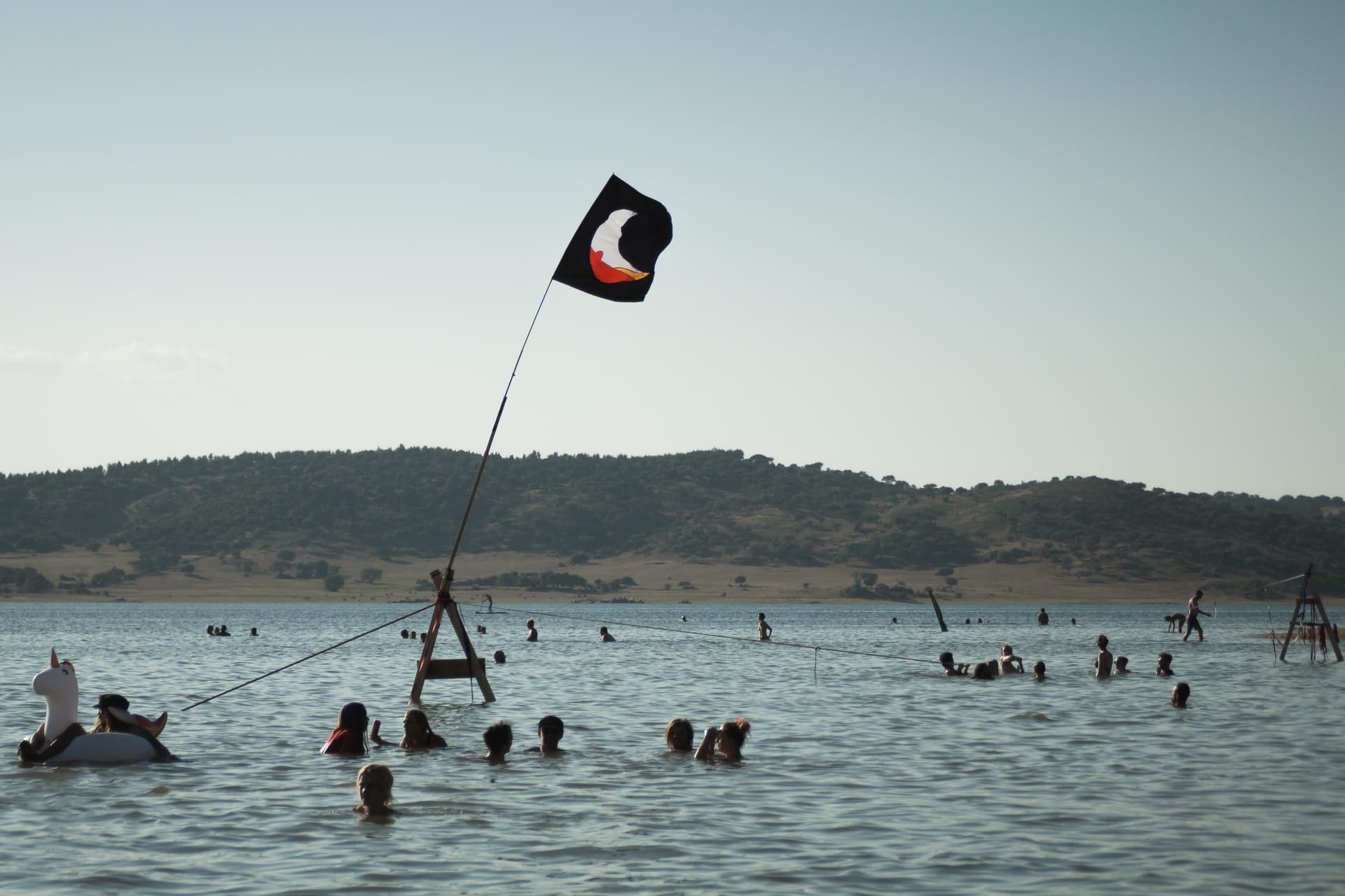 Flag and swimmers on the reservoir