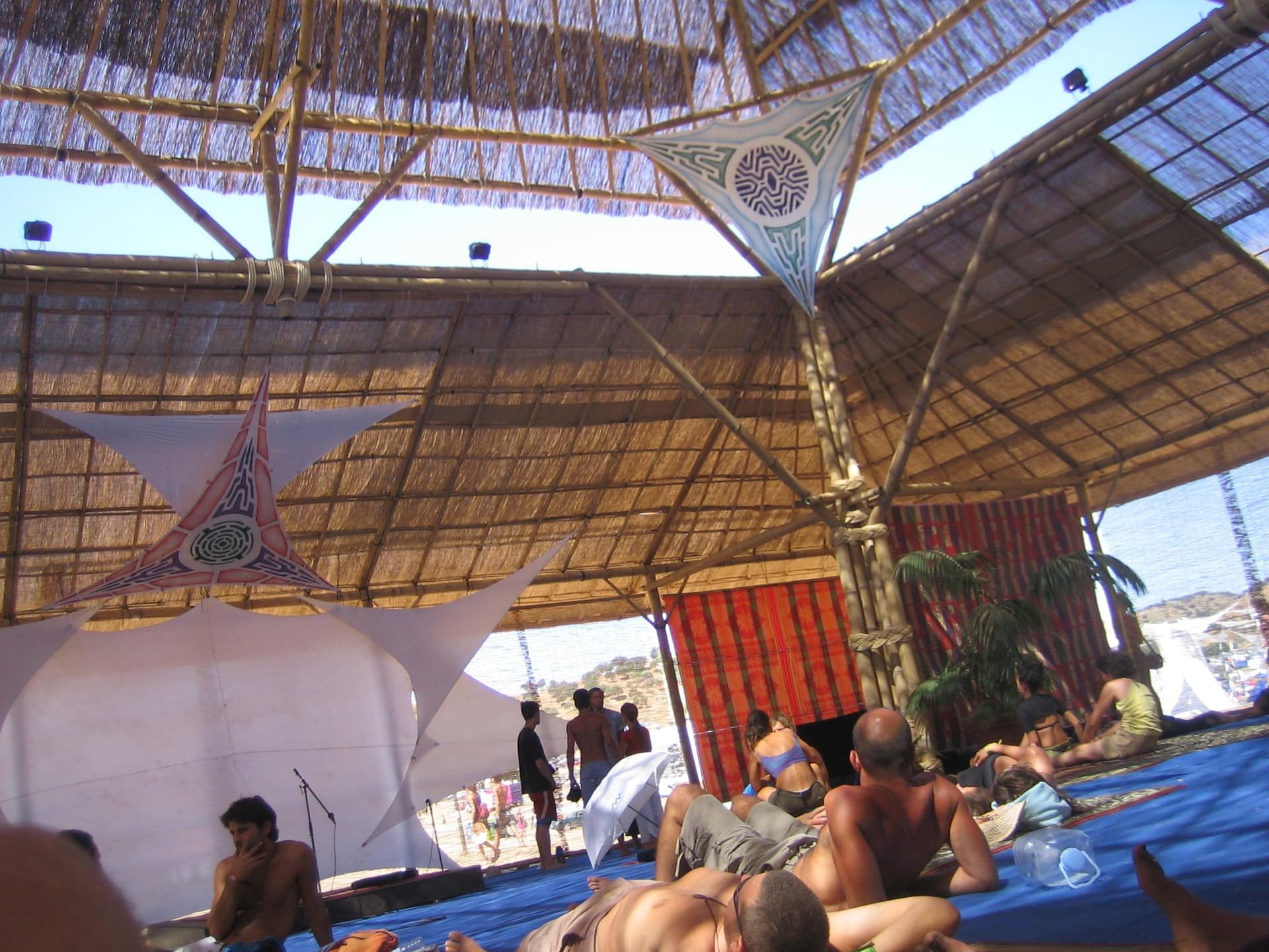 Visitors resting inside the bamboo pavilion