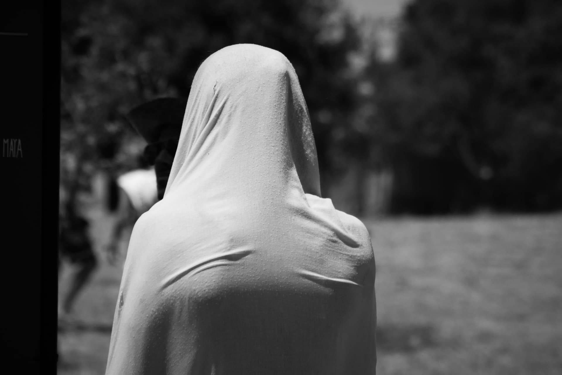 Figure in a white hood in monochrome