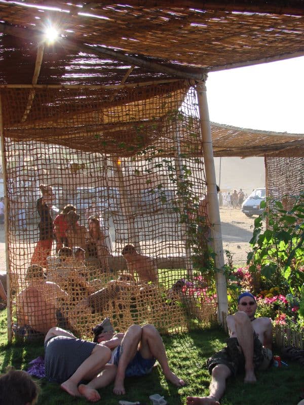 Netted shade shelter with visitors resting