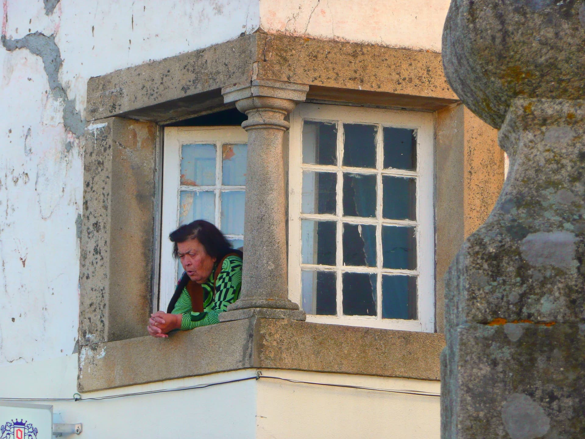 Woman at a window in Idanha-a-Nova