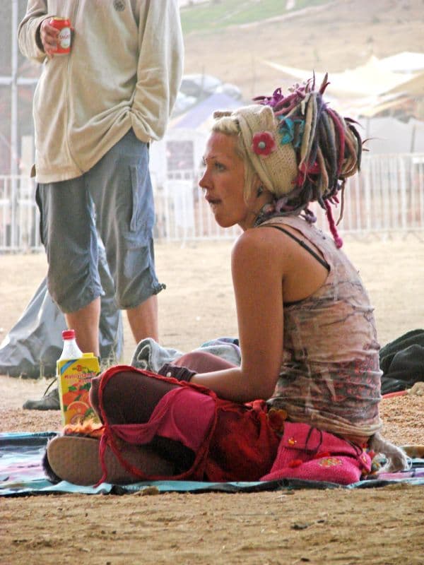 Visitors sitting outside their tents