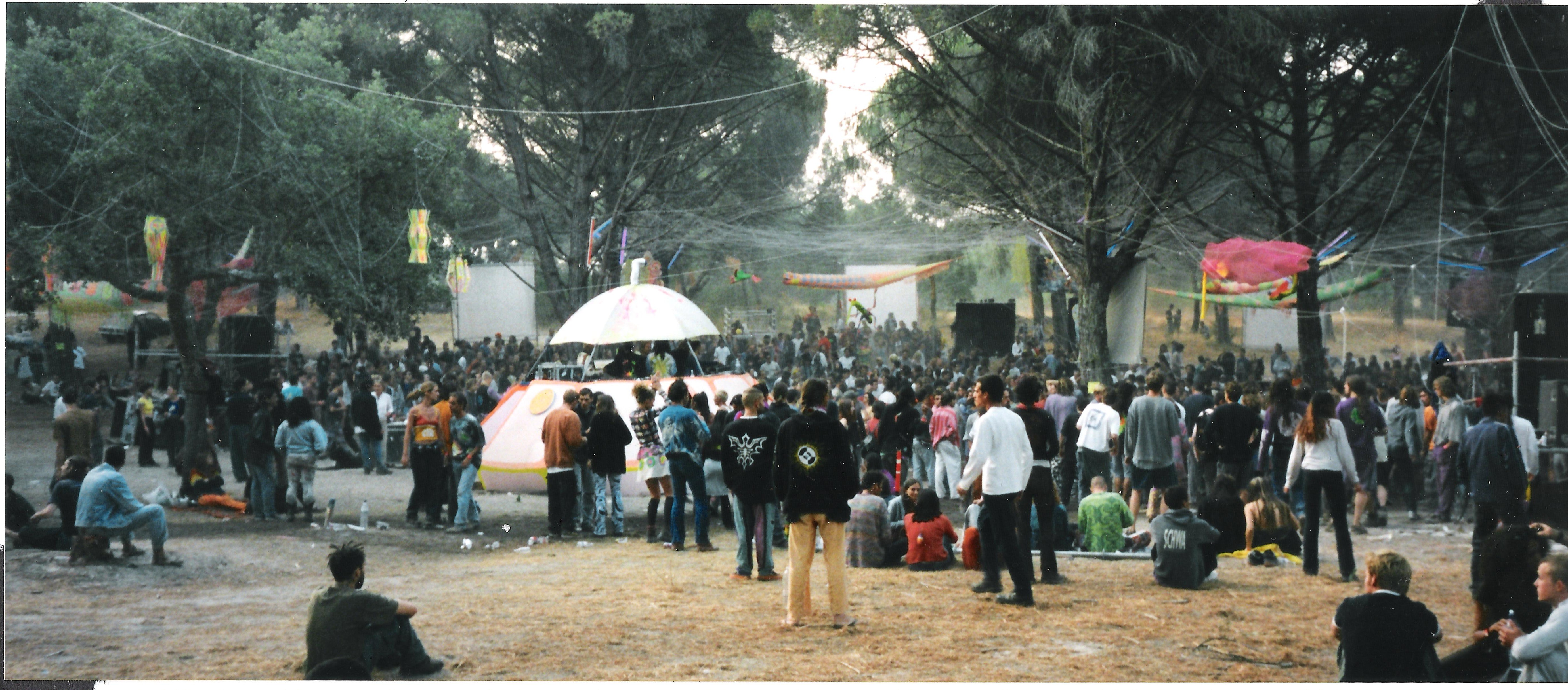 Crowd under the trees at the main dance area