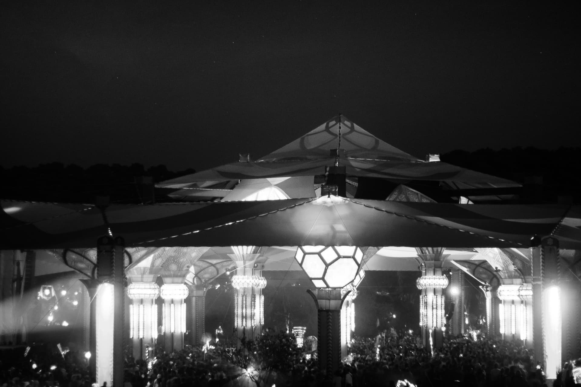 Lit pavilion at night in monochrome