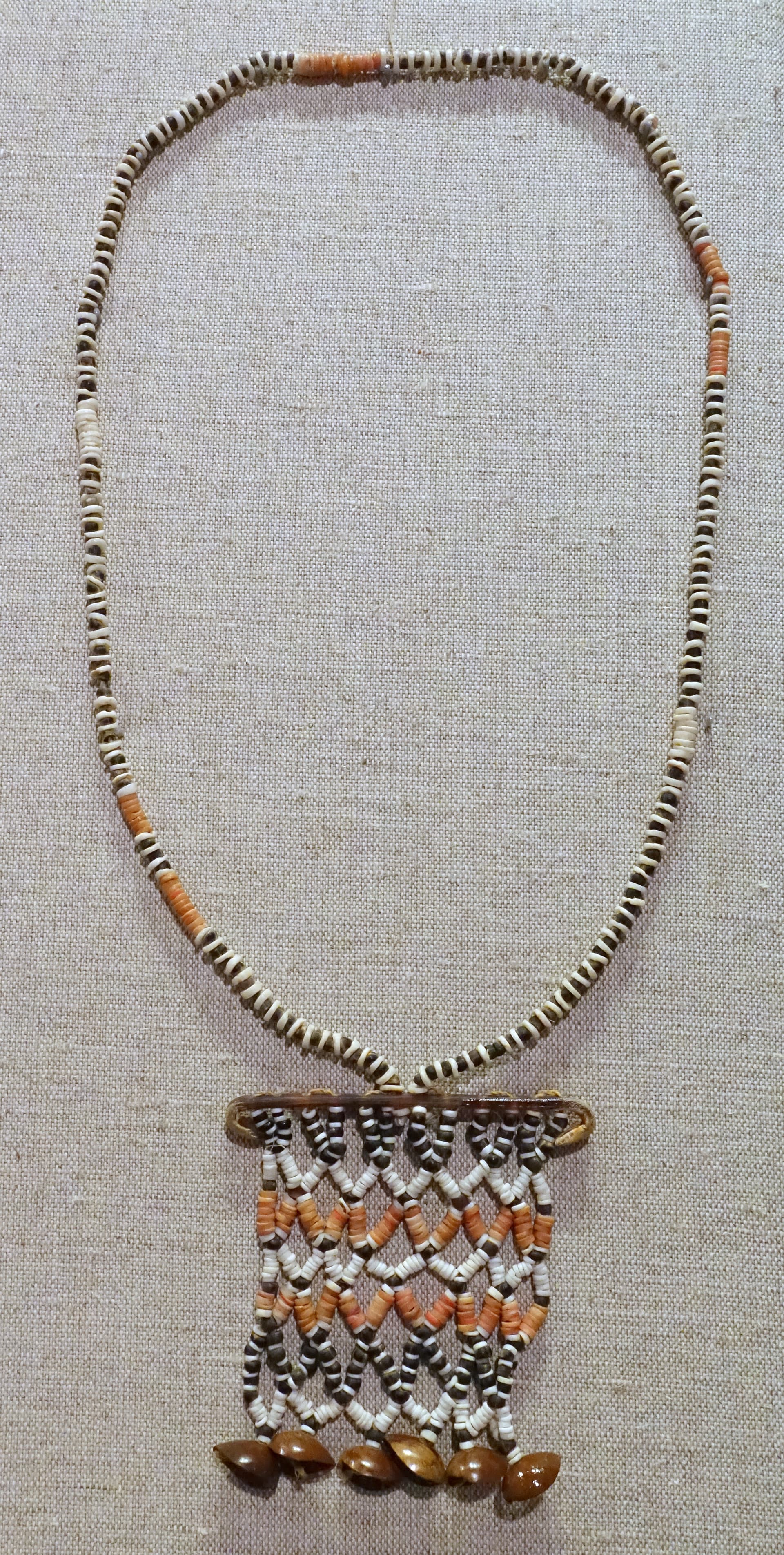 Disk necklace, Langu Langu Lagoon, Lau Lassi Village, Malaita Isle, Solomon Islands, 1900-1945, shell, coral, seed pod - Spurlock Museum, UIUC - DDSC06000